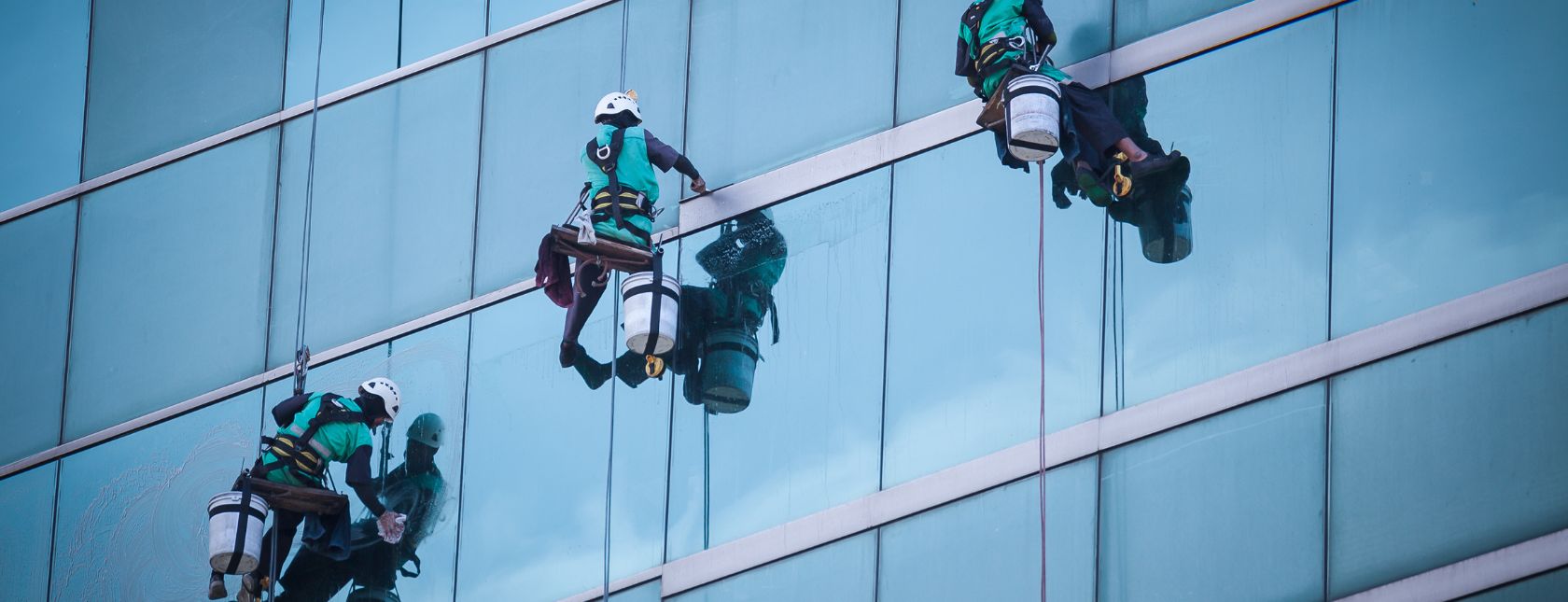 Group of workers cleaning windows service