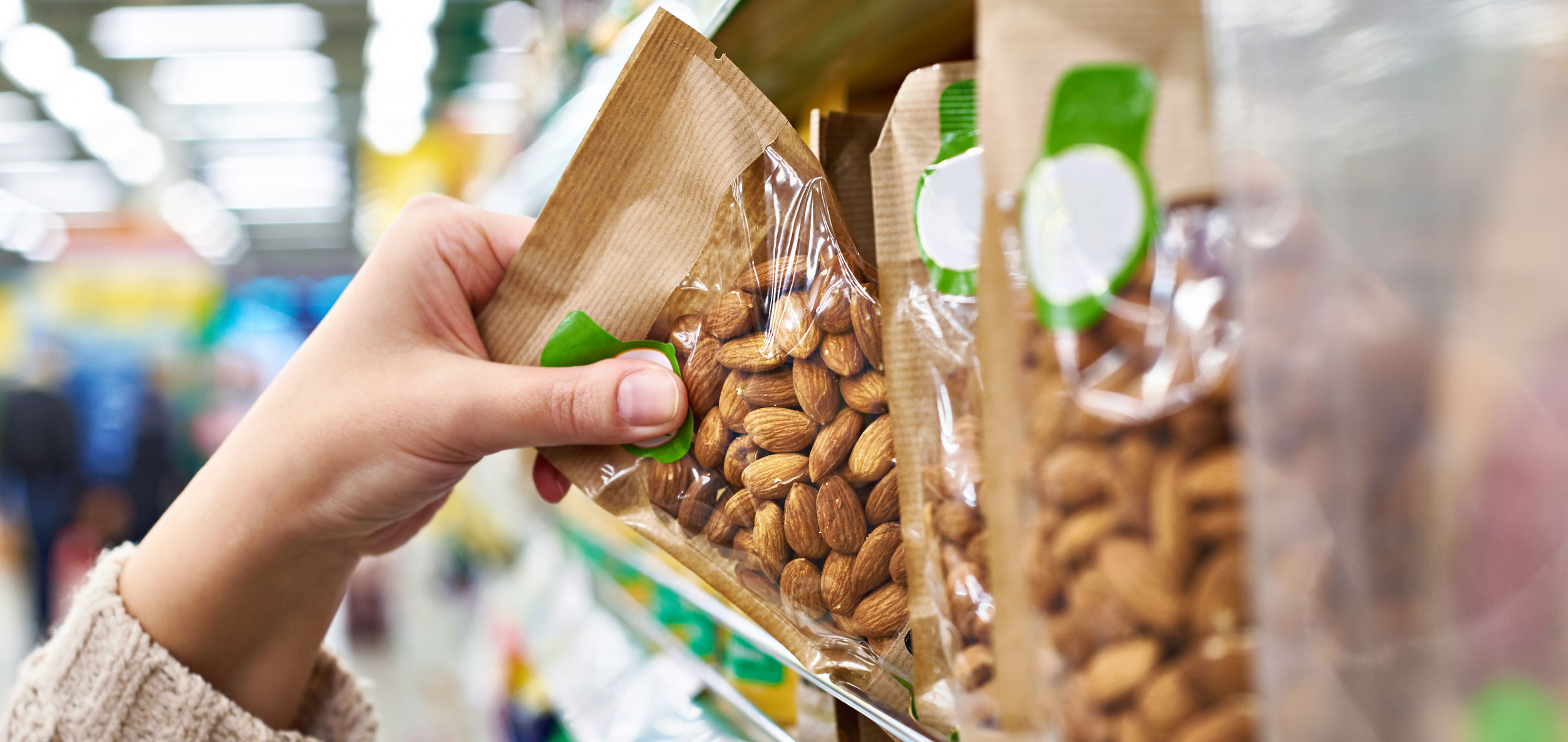 hand grabbing pack of almond